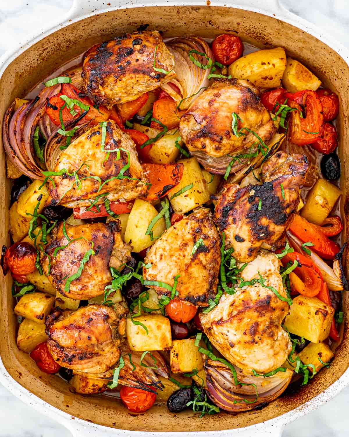 Roasted chicken legs and cherry tomatoes with garlic butter